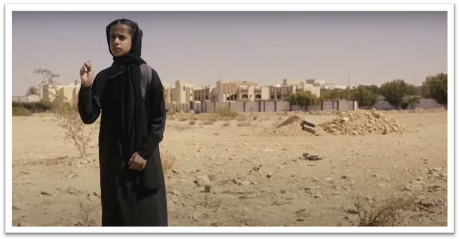 A girl in Saudi Arabia watches a green bicycle passing in front of her. She is transfixed by the vision and she follows it, magnetically drawn to it. 