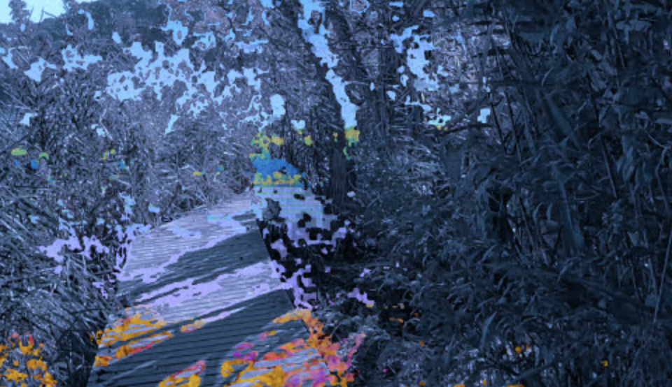 An image that appears to be of a bridge between dark, overgrown plants. While the majority of the image is in shades of purple, there are small flecks of gold, pink, orange and blue.