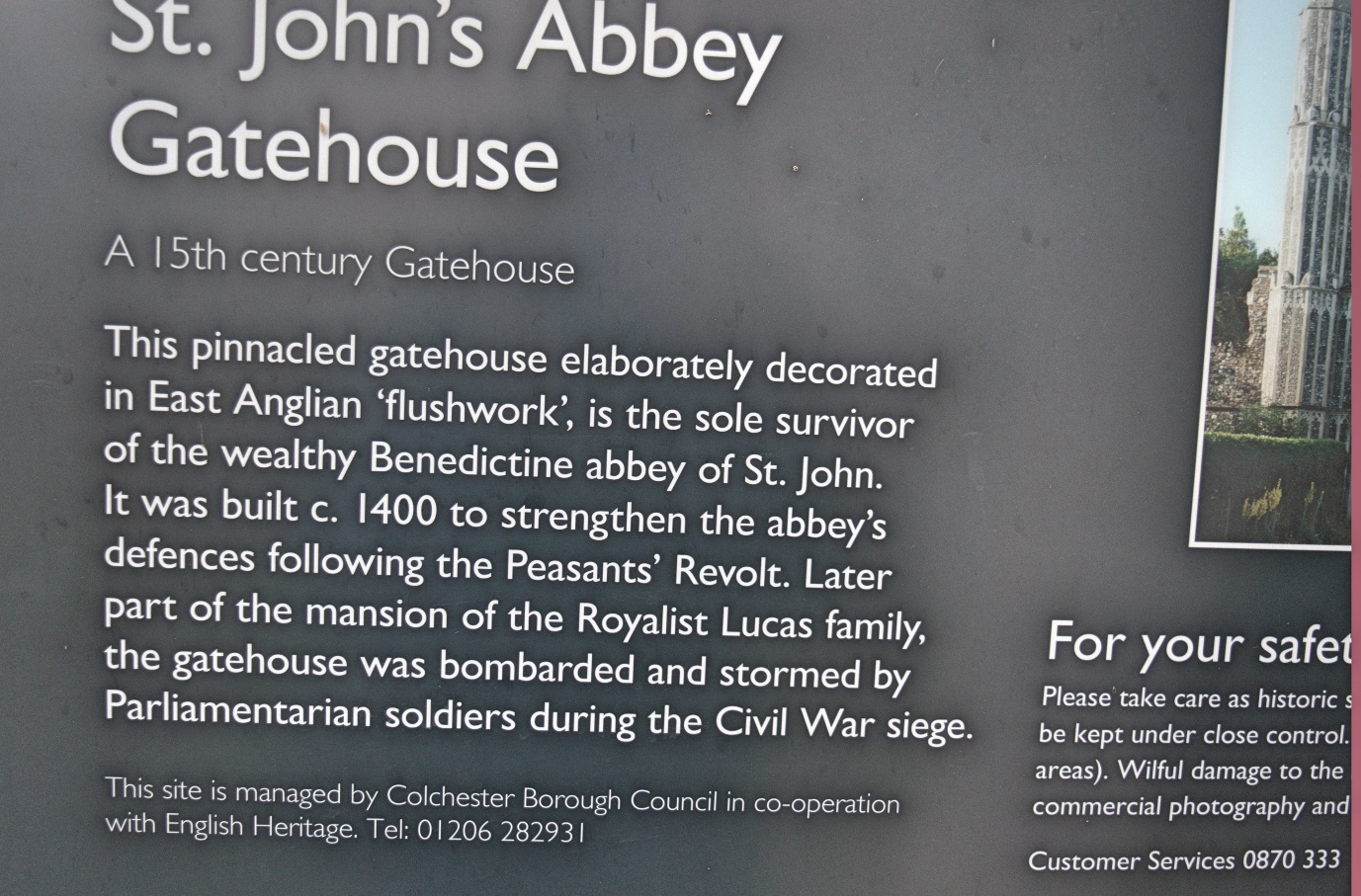 A close-up of sign introduce St. John's Abbey Gatehouse
