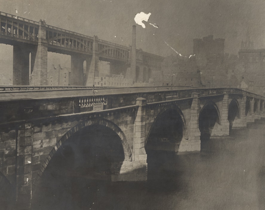 A bridge with a fire in the background AI-generated content may be incorrect.